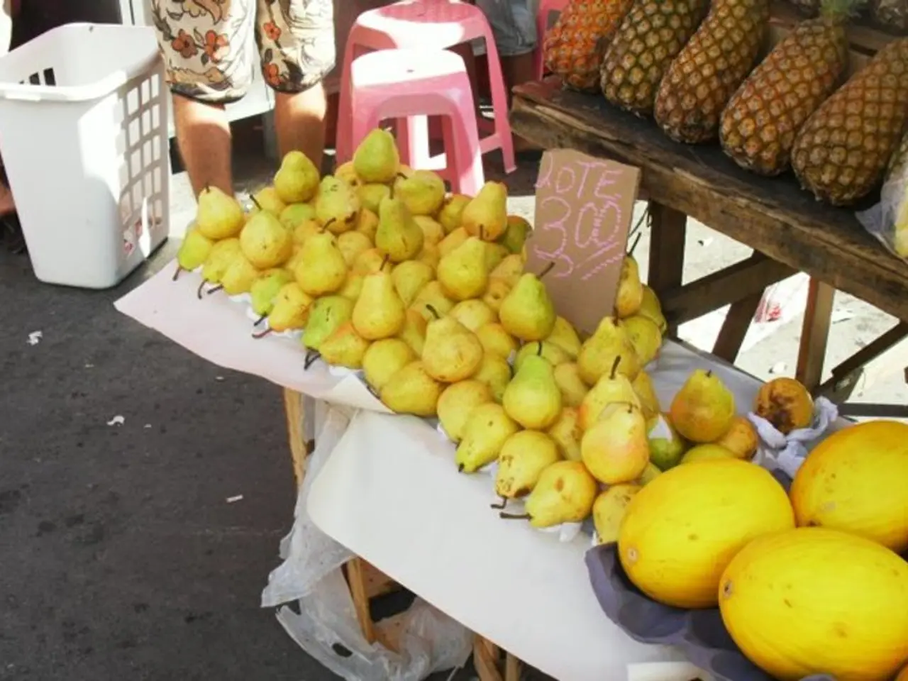 In this image we can see many fruits placed on the rack. There are few stools in the image. There...