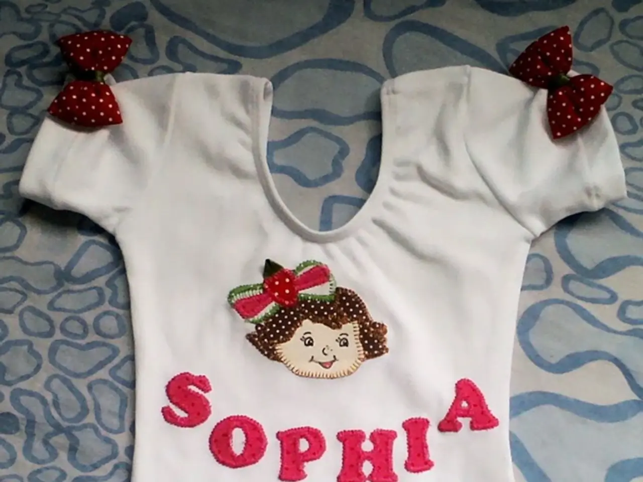 In this image I see a dress which is of white in color and I see a word written over here and it is...