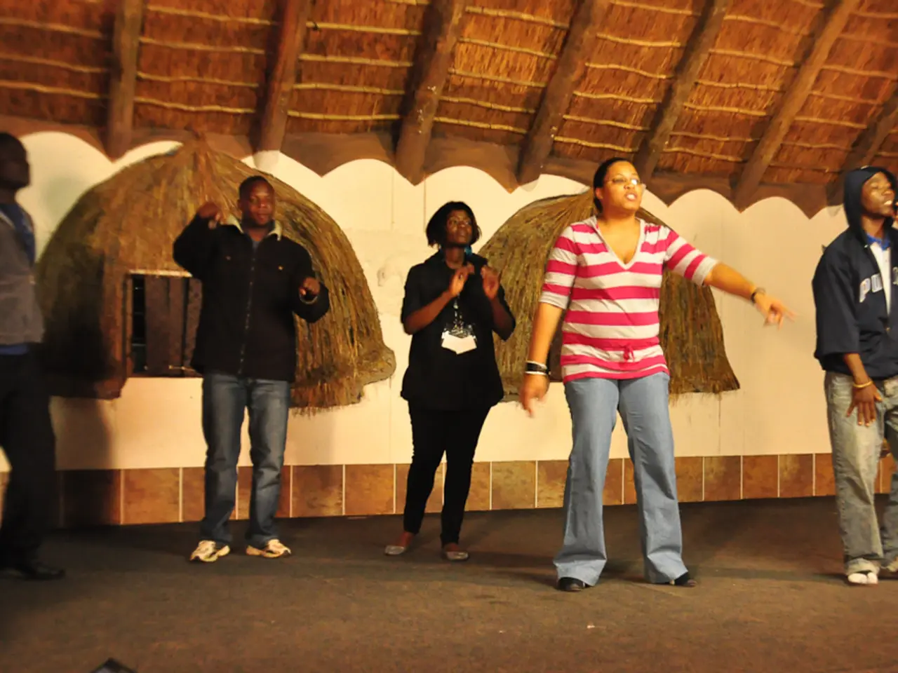 This picture seems to be clicked inside the room. In the center we can see the group of people...