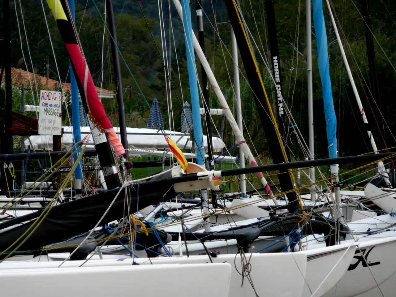 In this picture I can see number of boards, poles and ropes. In the middle of this picture I can...