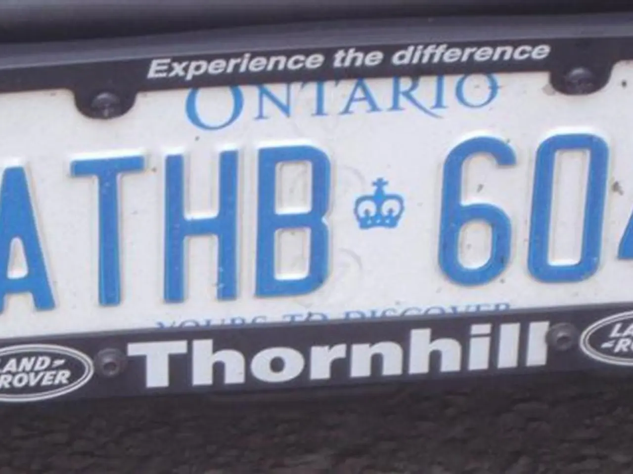 In the foreground of this picture, there is a number plate of a vehicle and text written as 'A THB...