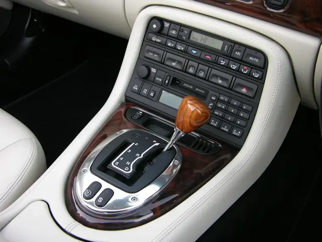 In this image we can see a car gear, here are the buttons on it.