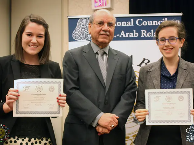 On the left side, there is a woman smiling, holding a certificate with both hands and standing....