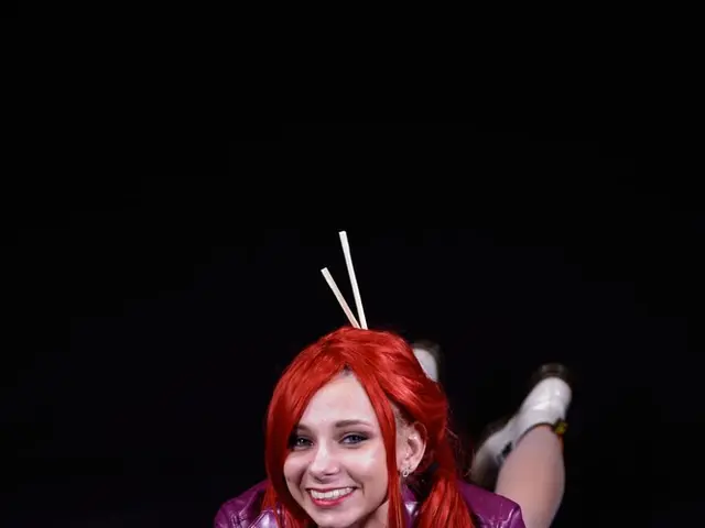 In this image we can see a woman lying on the surface and the background is black in color.