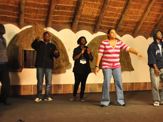 This picture seems to be clicked inside the room. In the center we can see the group of people...