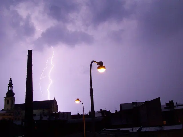 At the bottom of the image I can see many buildings and two street lights. In the background, I can...