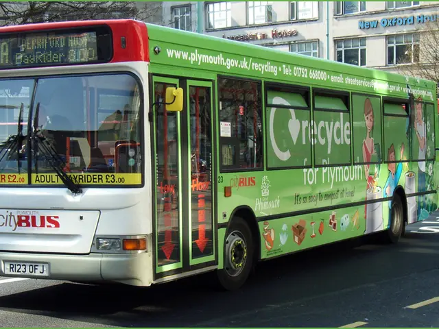 In this image we can see buses on the road. In the background we can see trees, buildings and...