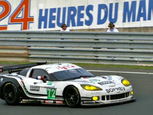 In this image I can see a sports car in white color on the road, in the middle there are iron...